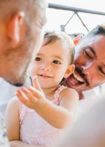 Image description Child touching father's face